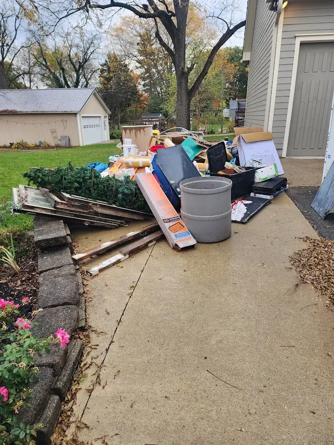 Dumpster being loaded with debris for 3 Yard Dumpster Rental in Derry